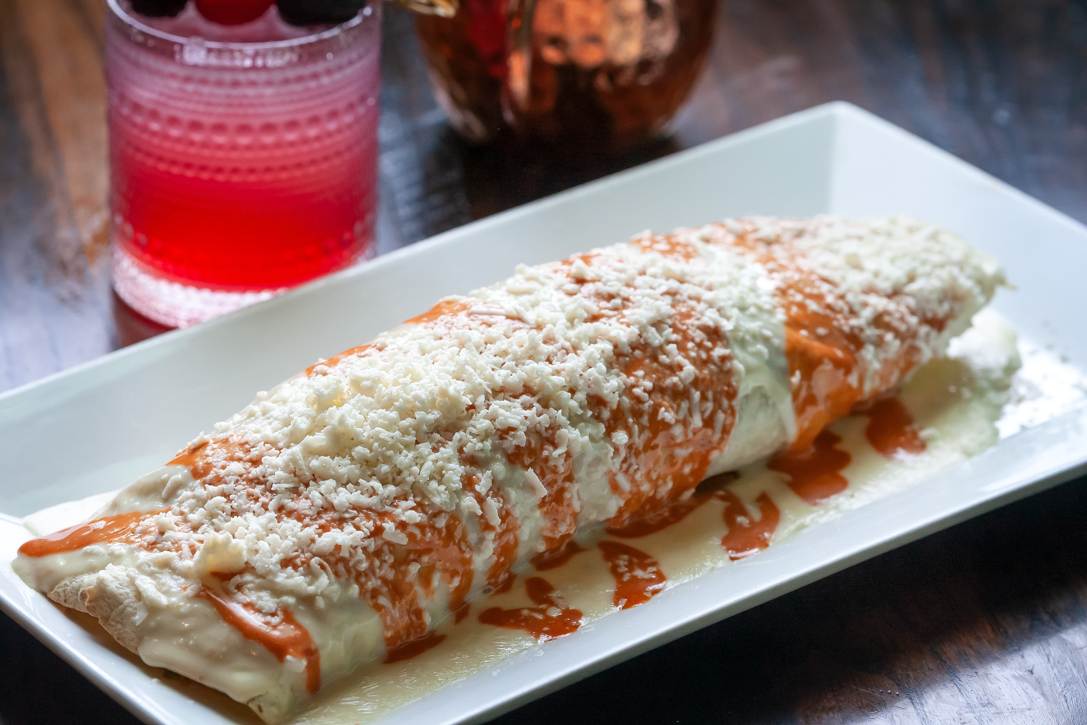 Bulldog Burrito with chipotle sauce and queso